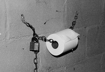 Toilet roll chained and padlocked to wall